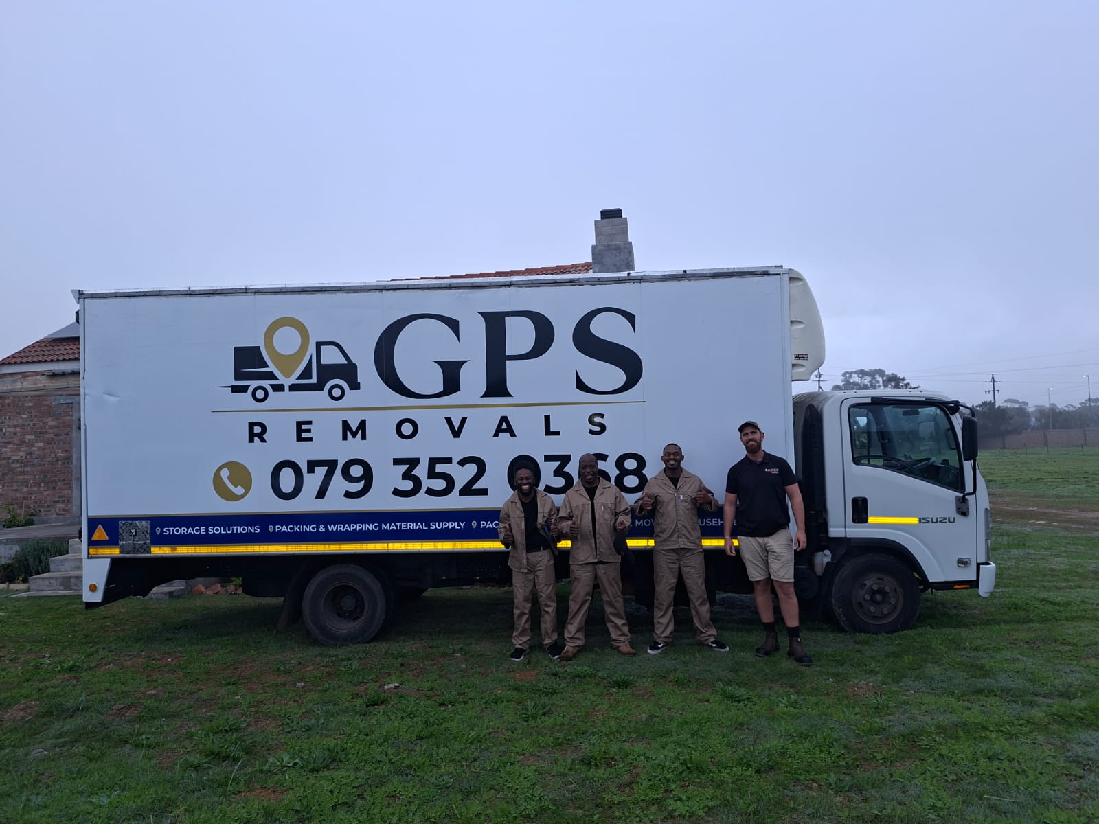 The GPS Removals crew beside the truck on a misty early morning