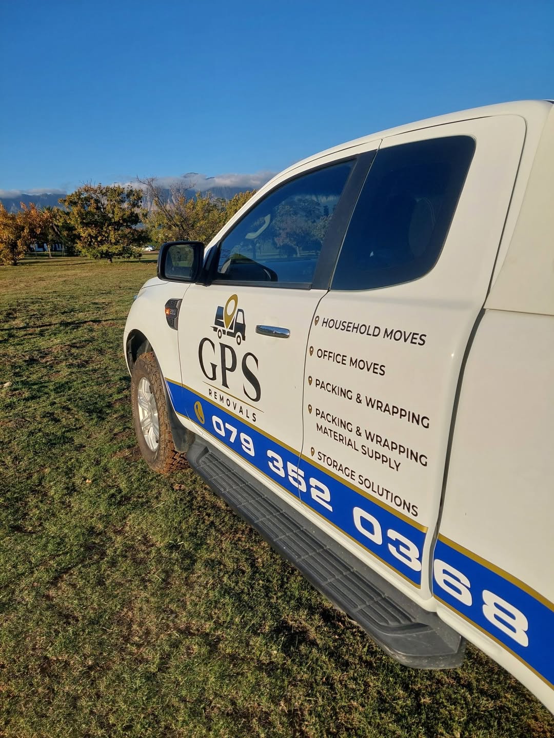 Close-up of the GPS Removals bakkie showing the services listed on the door